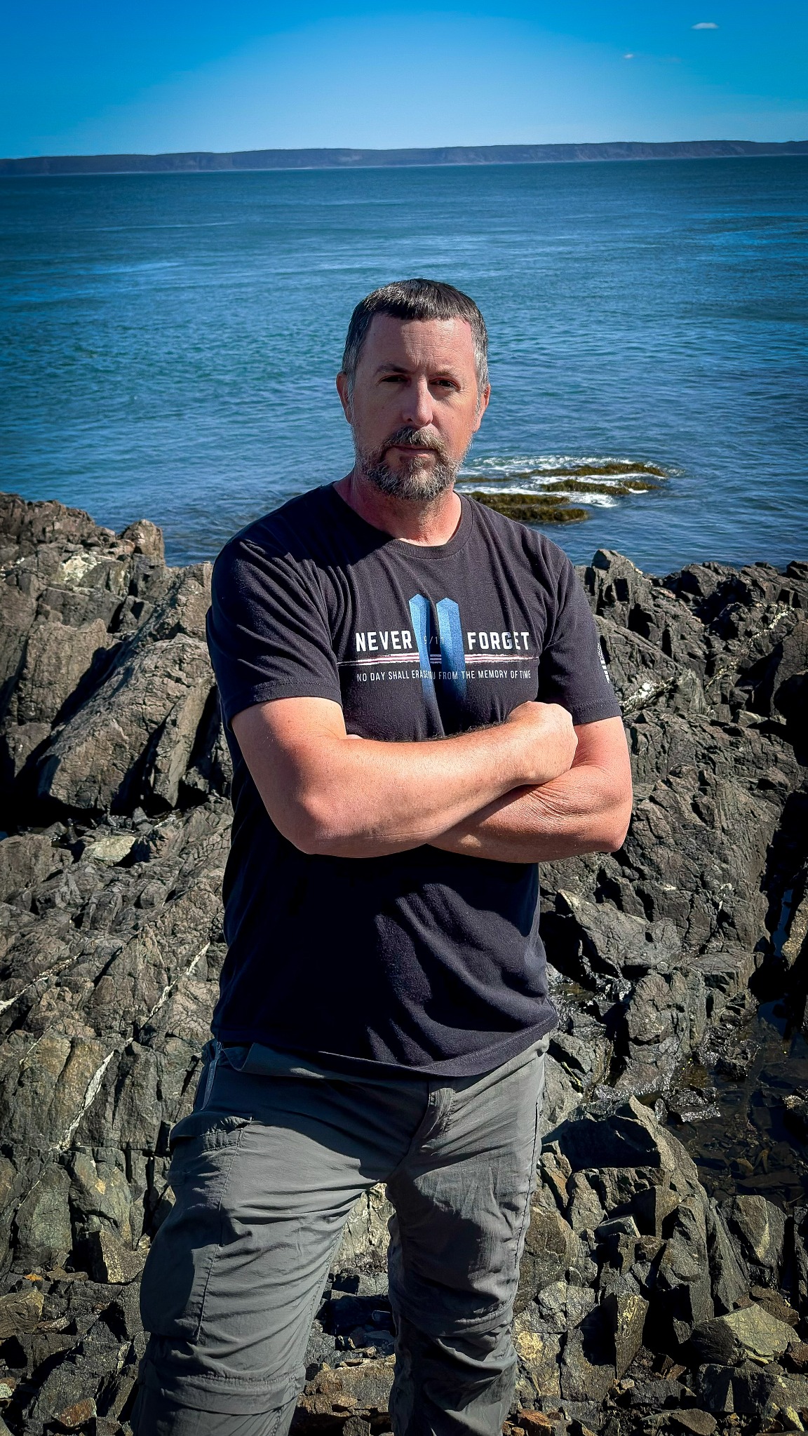 Author Steven Gallaher standing on a rocky coastline